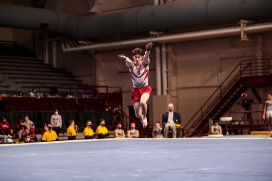 Zach Martin saluting with both arms raised on the competition floor